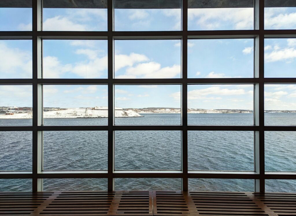 Sea Shore behind Building Windows